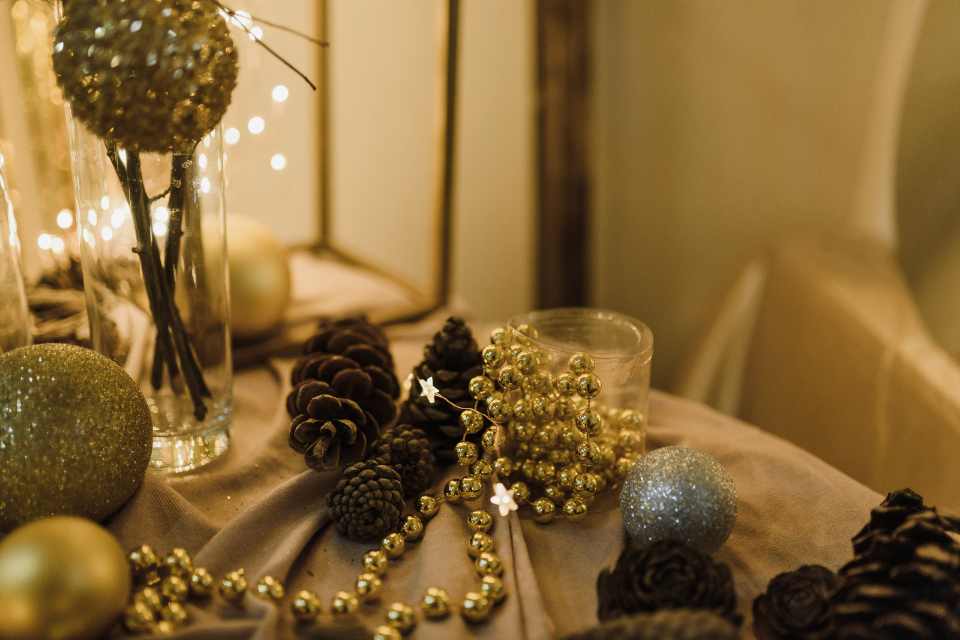 gold and silver beads on table with holiday decor
